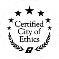 Black and white badge with five stars, laurel branches, and the text "Certified City of Ethics" in the center.