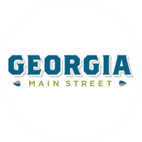 Logo of Georgia Main Street, featuring the word "GEORGIA" in bold blue letters and "MAIN STREET" in smaller green letters beneath it.