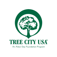 Logo of Tree City USA featuring a stylized tree inside a circle, with text "Tree City USA" and "An Arbor Day Foundation Program" below.