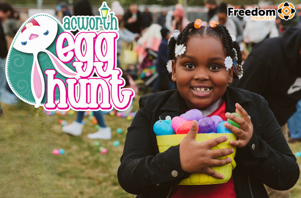 A smiling child holds a yellow basket filled with colorful plastic eggs at the Acworth Egg Hunt, with cheerful crowds and festive Acworth Egg Hunt signage in the background.