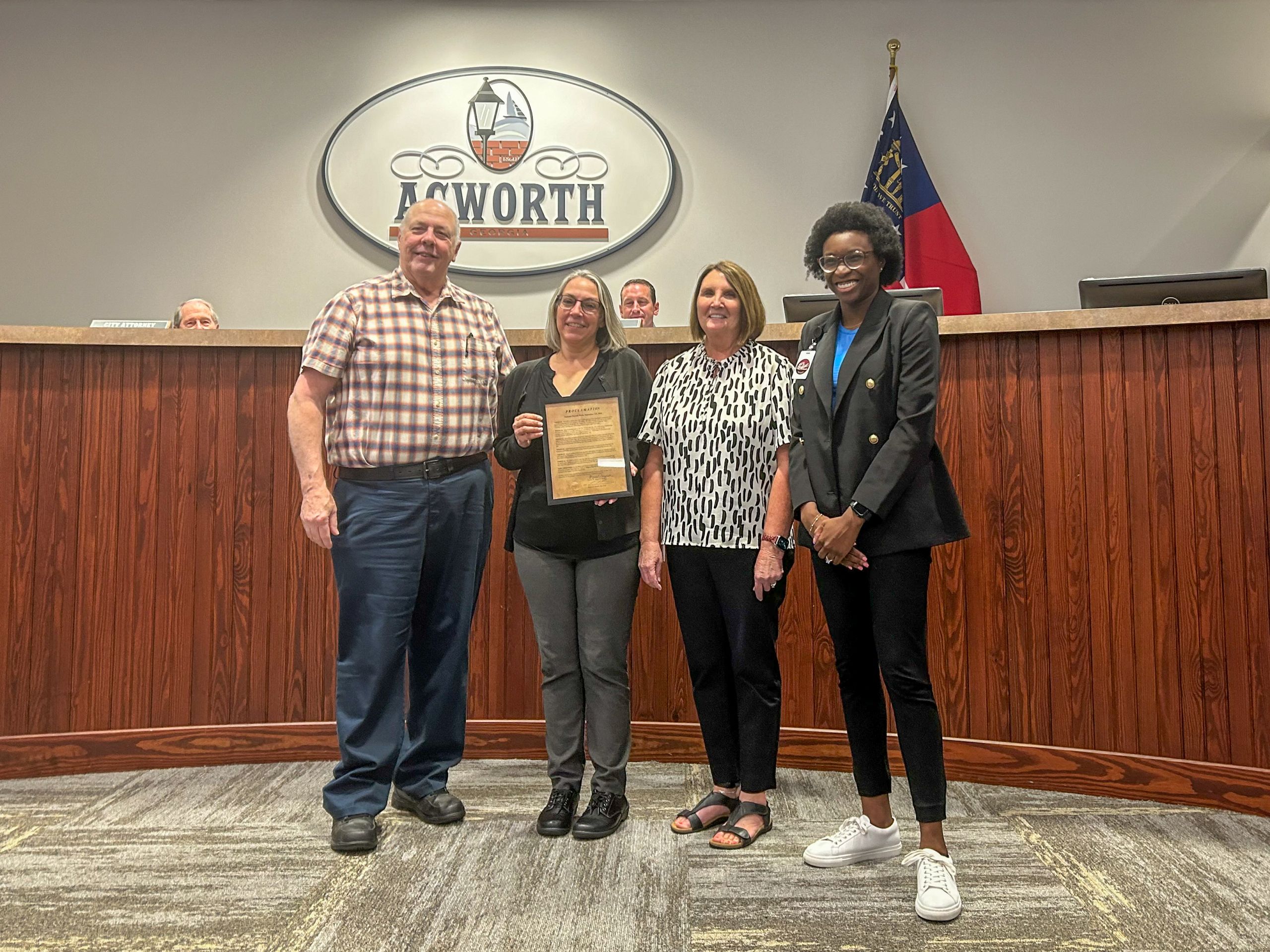 Image Four People Holding a Proclamation in Acworth City Council Chambers