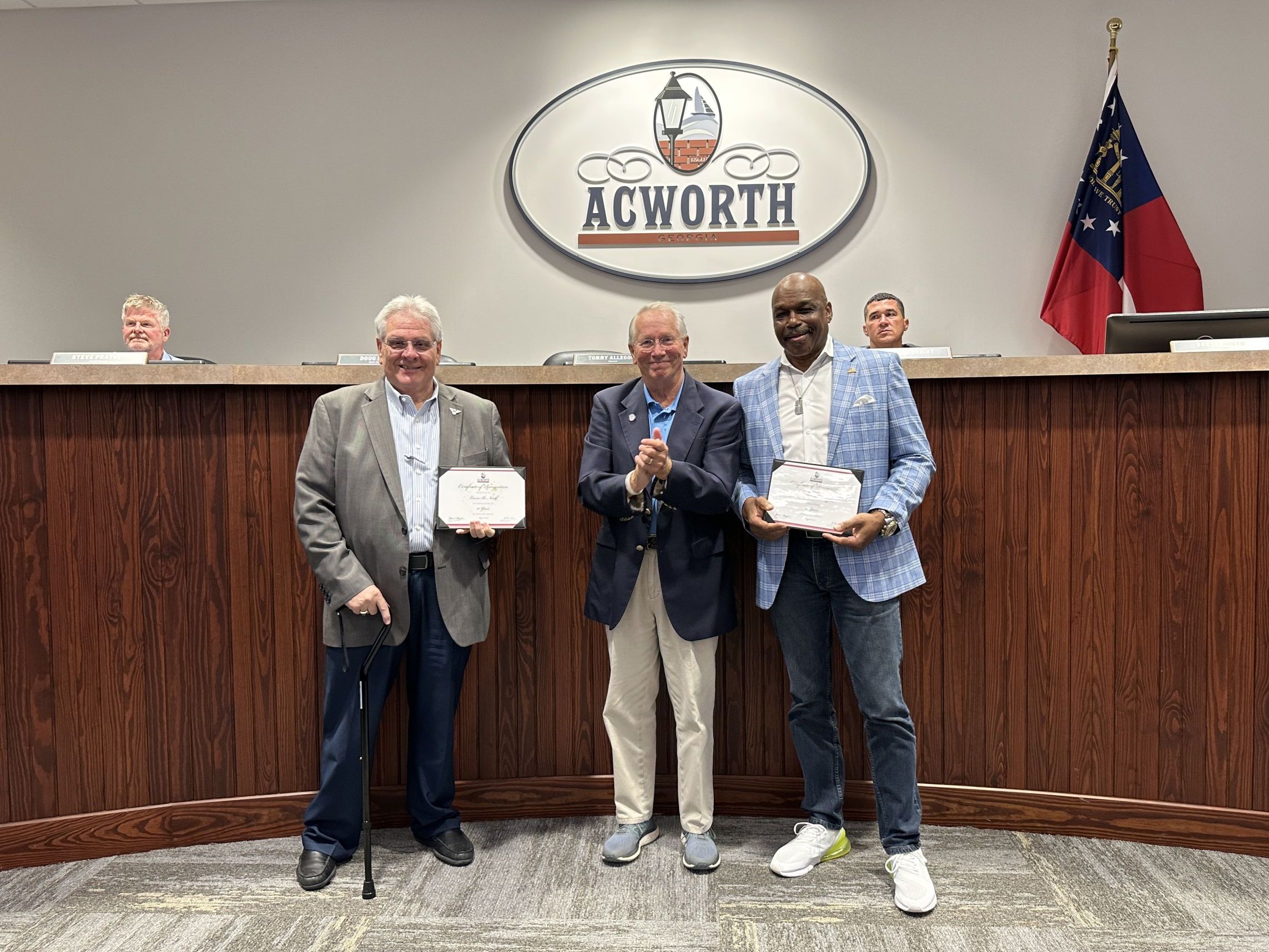 Image Three men standing in Acworth City Council chambers with certificates