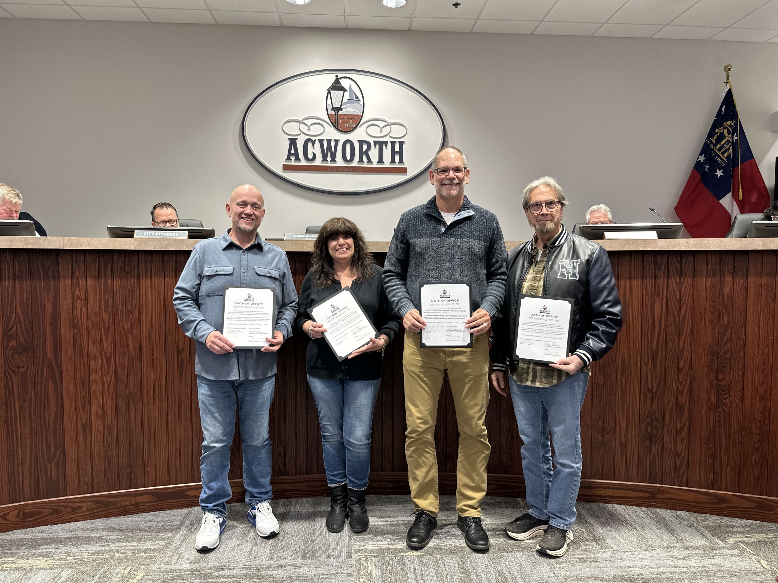 A group of people holding certificates during the swearing in of new Board and Commission Members for 2026.