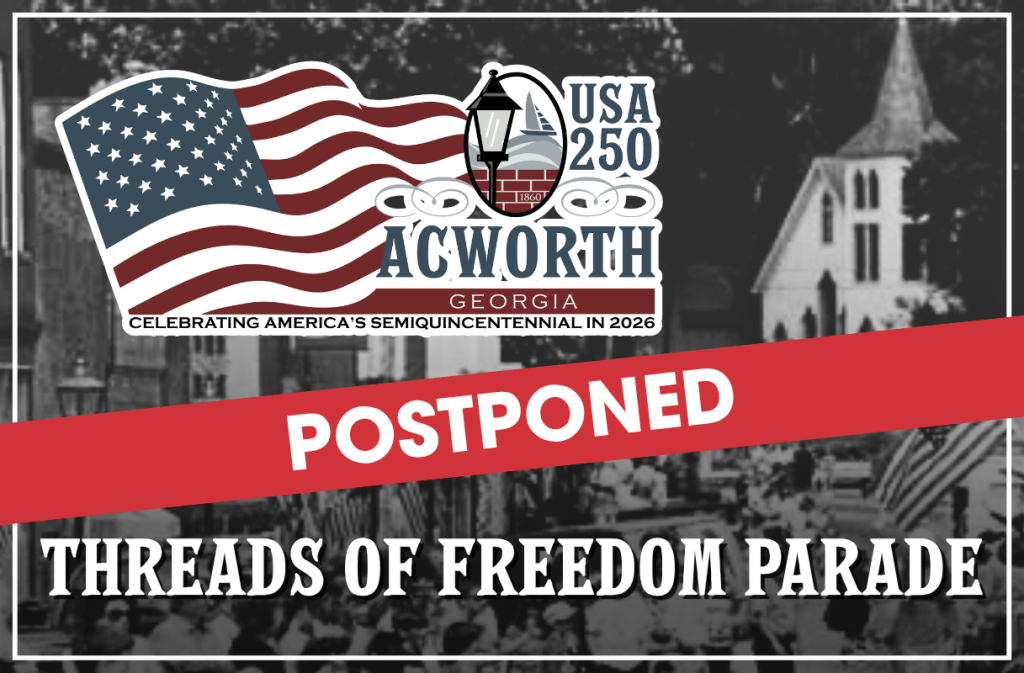 A banner announces the postponement of the Threads of Freedom Parade in Acworth, Georgia, part of the USA 250 Semiquincentennial celebration in 2026.
